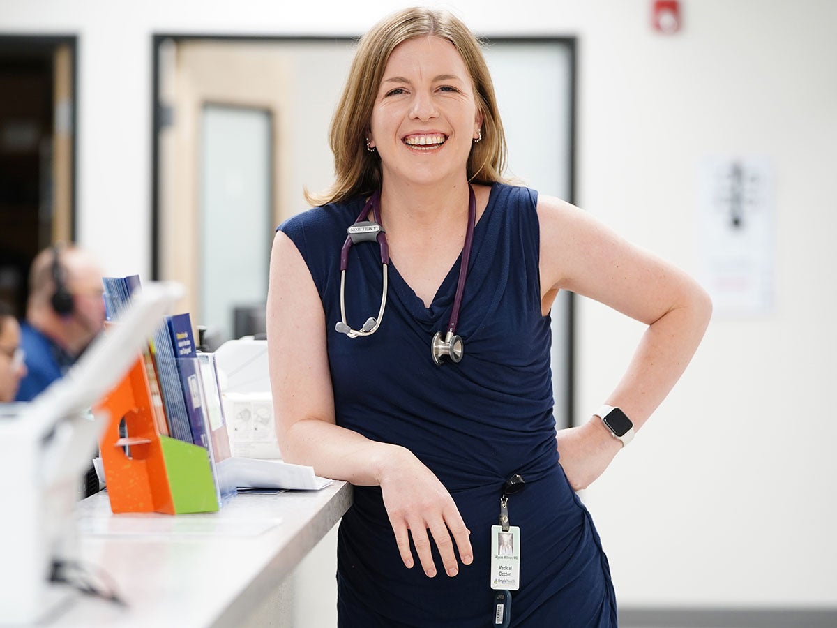 increasing diversity of medical students. A physician with a stethoscope around her neck is shown in the medical clinic where she practices. 
