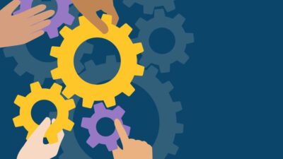 Hands putting gears together.